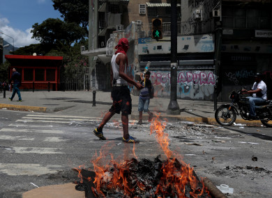 A demonstrator blocks a street during a rally against Venezuela's President Nicolas Maduro's government in Caracas.
