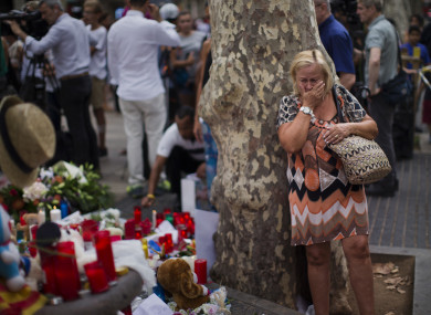 A woman cries at a memorial in Barcelona.