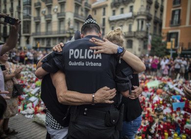 A policeman hugs to a boy and his family that he helped during the terrorist attack.