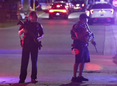 Two law enforcement officers stand guard following a shooting in Florida.