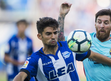 Alaves' Enzo Zidane (left) competes for the ball with Lionel Messi.