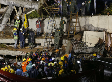 Rescue personnel work on the rescue of a trapped child at the collapsed Enrique Rebsamen primary schoool
