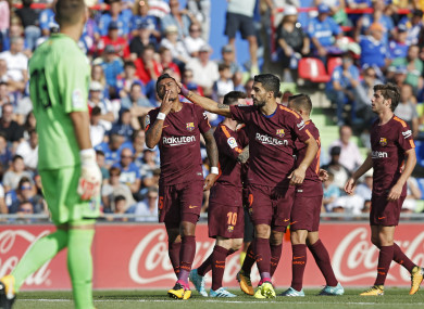 Barcelona's Paulinho, left, celebrates with teammate Luis Suarez after scoring against Getafe.