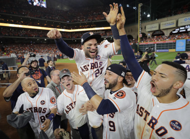 Houston Astros' Jose Altuve is lifted by teammates after Game 7 of baseball's American League Championship Series.