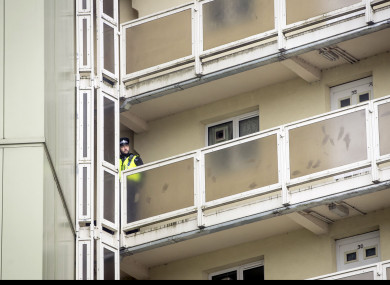 A police officer leaves Newcastle House in Bradford, where the 18-month-old baby died following a fall from a sixth-floor window.
