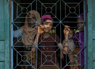 Newly arrived Rohingya Muslims from Myanmar look out from a madrasa window that they used as a shelter in Shahparirdwip, Bangladesh.