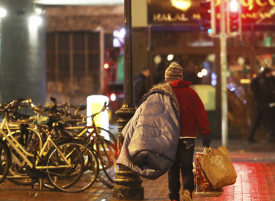 File photo of a rough sleeper walking through Dublin city.