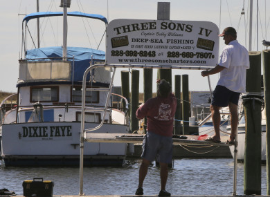 Boat renters take down their sign in Biloxi, Mississippi as residents brace for the arrival of the storm