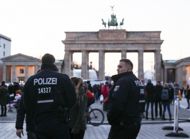 Two policemen stand guard in front of the Brandenburg Gate in Berlin.