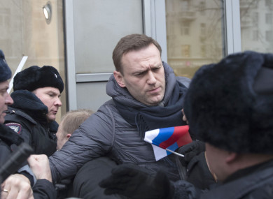 Russian opposition leader Alexei Navalny, centre, is detained by police officers in Moscow, Russia.