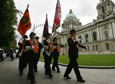 The Orange Order march past City Hall in Belfast.