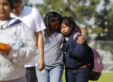 People pick up students after the shooting at the LA school