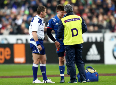 Jalibert prepares to depart injured after clashing with Bundee Aki.