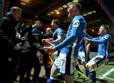 Goalscorer Steve Davies celebrates with team-mates and fans.