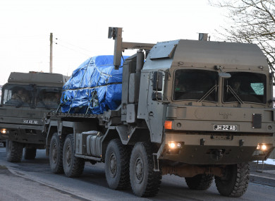 A vehicle of interest wrapped up in blue tarpaulin near the scene of the poisoning