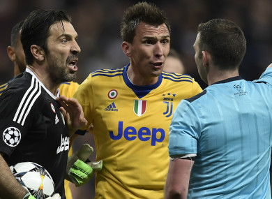 Buffon confronts Oliver after his controversial decision.