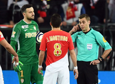 Monaco players Joao Moutinho and Danijel Subasic with referee Clement Turpin during yesterday's final.