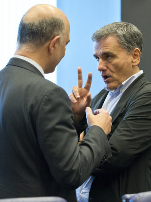Greek finance minister Euclid Tsakalotos making a point to an EU colleague.