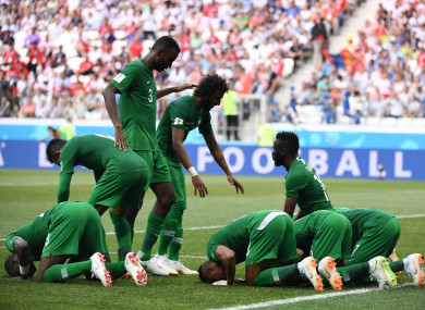 The Saudi players celebrate scoring.