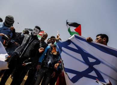 Protesters set fire to an Israeli flag bearing the picture of Israeli Defence Minister Avigdor Lieberman during clashes.