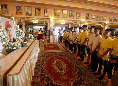 Members of the rescued soccer team pay their respect to Saman Gunan, who died during their rescue attempt.
