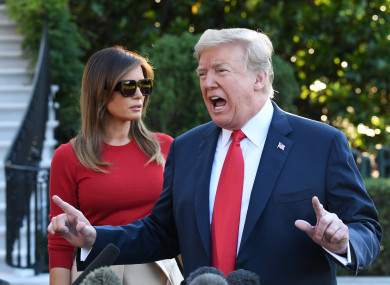 President Donald Trump talks to the press with first lady Melania Trump as he makes his way on the South Lawn towards Marine One to depart for Europe.