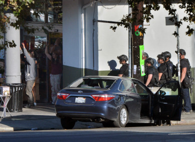 The suspect exits the Trader Joe's supermarket and is taken into custody.