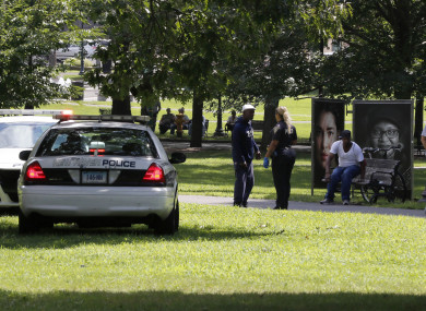 A police officer speaks to a man walking on New Haven Green, Connecticut