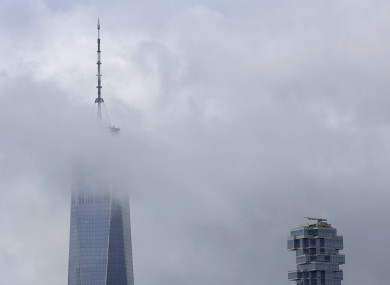Clouds break and the sky clears around the Spire of One World Trade Center and the Jenga Building, August 2018.