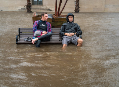Chris Craig and Zach Boucher sit on a bench following Hurricane Florence.