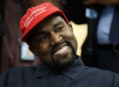 Kanye West smiles as he listens to a question from a reporter during a meeting in the Oval Office of the White House with President Donald Trump