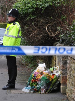 Police guard the entrance to Joanna Yeates's flat in Bristol.