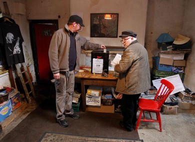 Ciaran McInerney casts his vote beside Hugh O'Donald, presiding officer, during voting on Inishfree Island this morning.