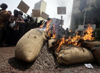Cocoa growers protest an export ban by burning sacks of cocoa beans in Abidjan, Ivory Coast, in mid-February 2010.