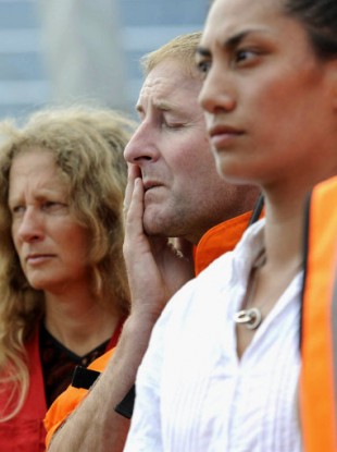 A man wipes away tears as people offer a moment of silent prayer in Christchurch, New Zealand, on March 1, 2011, a week after an earthquake devastated the area.