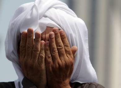 An anti-government protester prays in Bahrain yesterday. Irish citizens have been advised not to travel to the country unless absolutely necessary.