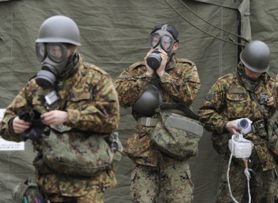 Members of the Japan Self-Defense Forces wearing protective gear get ready for radioactive decontamination operations in Nihommatsu, near the Fukushima I plant.
