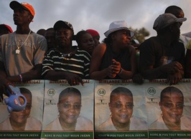 People gather with images of Haitian presidential candidate Mirlande Manigat at a campaign rally on Friday.