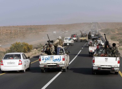 Rebel vehicles hit the road out of Ras Lanouf on the way to Sirte, home town of Muammar Gaddafi.