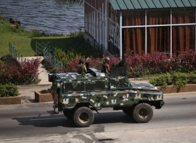 Troops supporting former president Laurent Gbagbo drive past in a armoured car in the city of Abidjan.