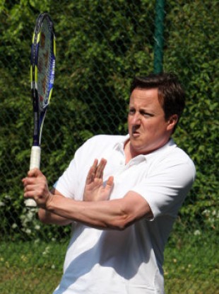 British Prime Minister David Cameron showing off his tennis skills at a charity match in England today.