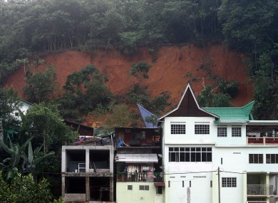 An orphanage, partially seen at left in background, is half-buried by a landslide in Hulu Langat in central Selangor state, outside Kuala Lumpur, Malaysia on Saturday.