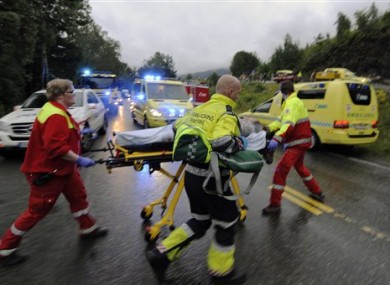 Emergency response personnel escort an injured person from the camp site on Utoya.