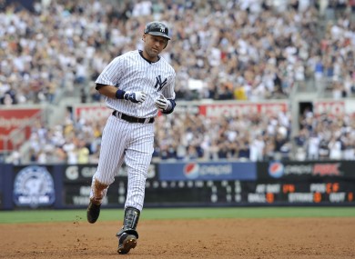 Derek Jeter rounds third base after he hit a solo home run, his 3,000th career hit off against the Tampa Bay Rays.