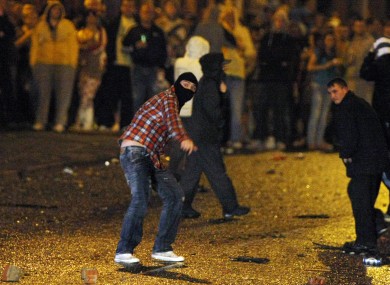 Rioters attack police lines in Belfast on Monday night. Further sectarian disturbances broke out in Portadown last night.
