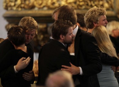 People embrace at the end of today's memorial service at Oslo Cathedral.