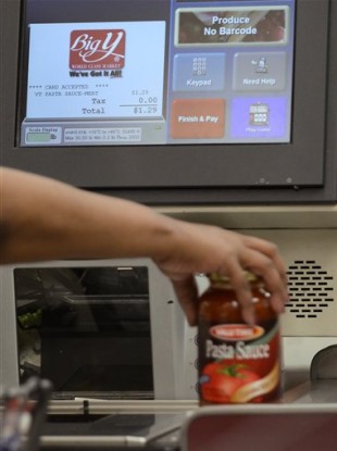 A shopper uses a self-service checkout at a supermarket in Connecticut. Some supermarket chains are beginning to phase out the self-service checkouts, saying they actually slow down the payment process.