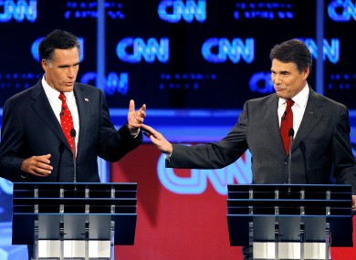 Mitt Romney and Rick Perry share a moment in last night's debate.