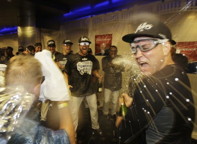 New York Yankees' Nick Swisher (centre), Mark Teixeira (centre left) and teammates celebrate.