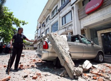 A mnivan in Kuta, Bali crushed by falling concrete during the earthquake.
